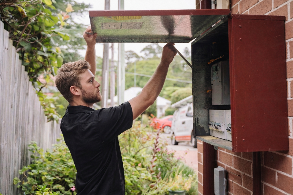 Electrician installing downlights in a Haberfield home